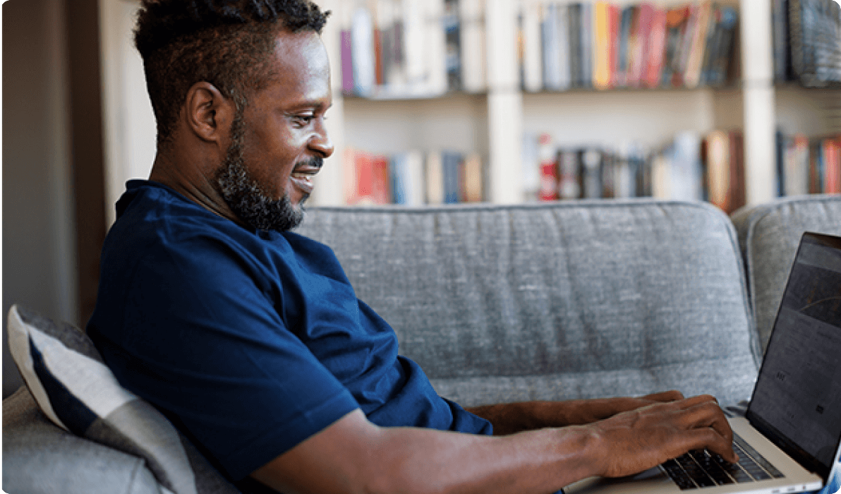 man using laptop on couch