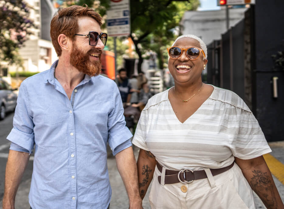 Man and woman laughing and walking