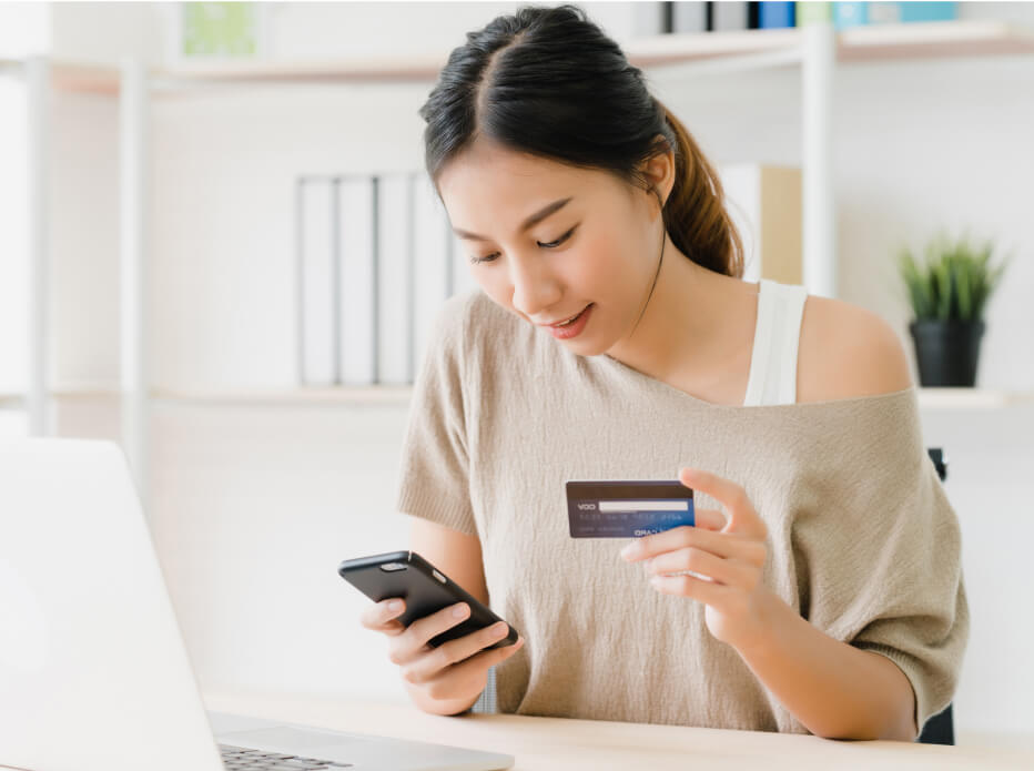 young girl with debit card and phone