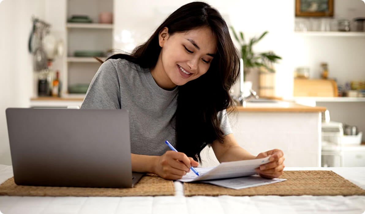 girl on computer with documents at home