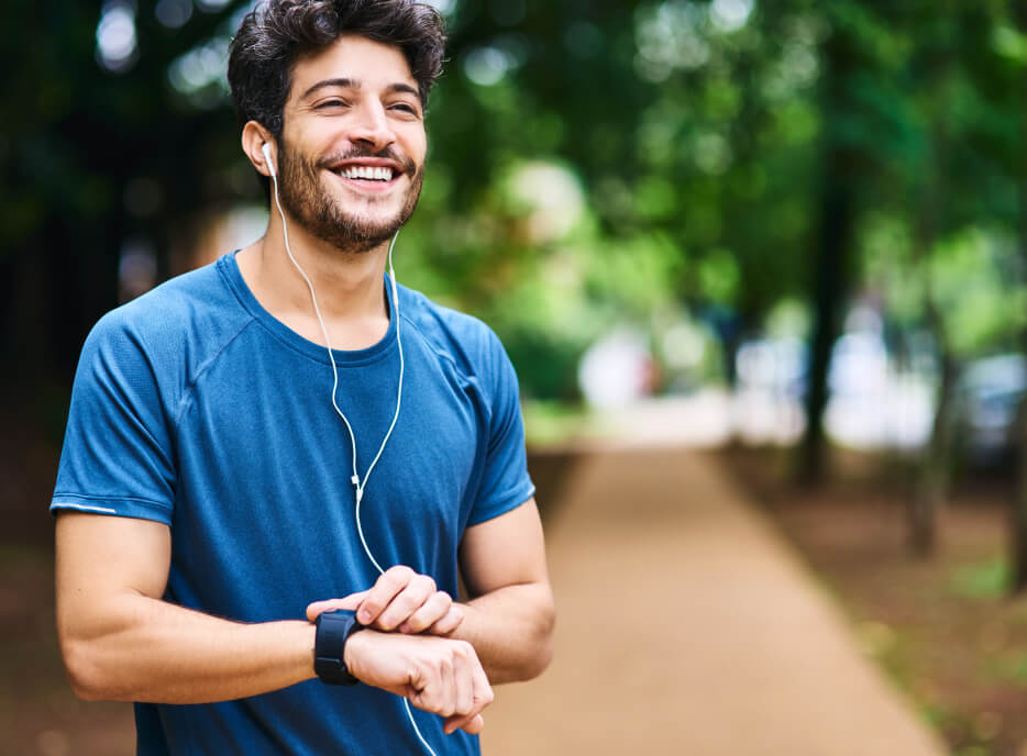 Man with earbuds exercising