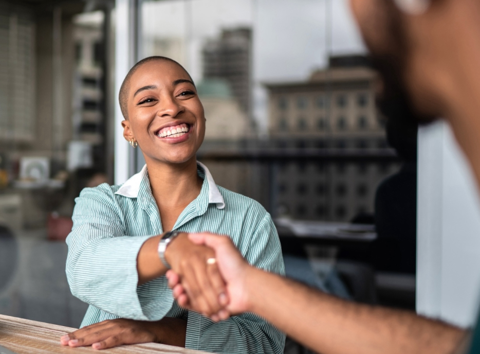 happy lady shaking hand with client