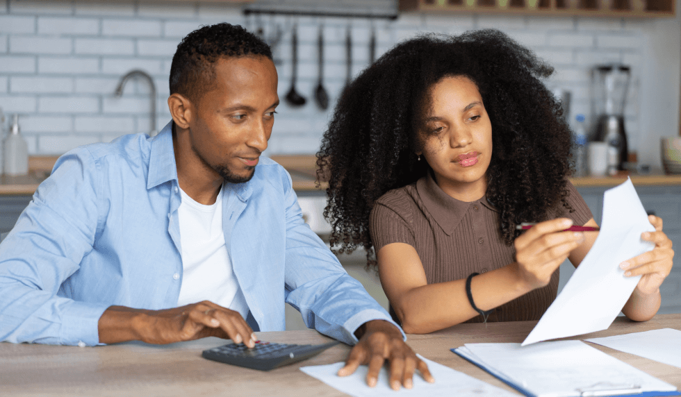 couple doing calculations at home