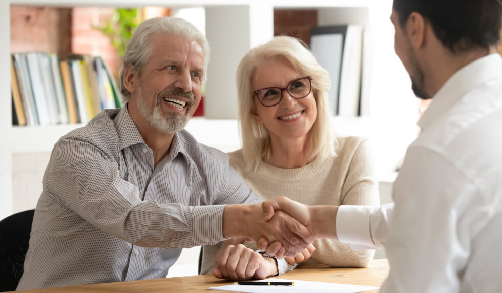 Elderly couple speaking with a representative