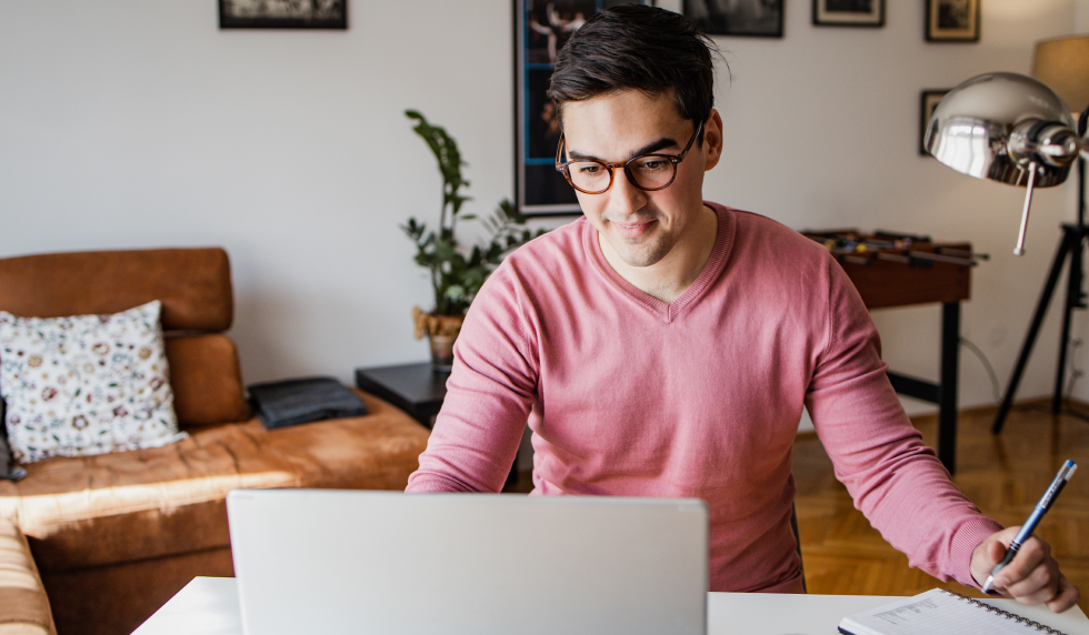 Young man at computer reading