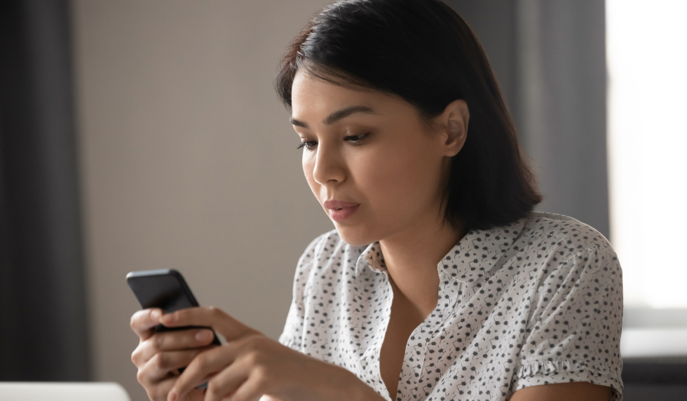 Woman concerned and looking at her phone 