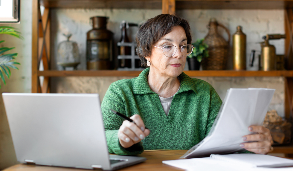 Elderly woman looking at her mail at her computer