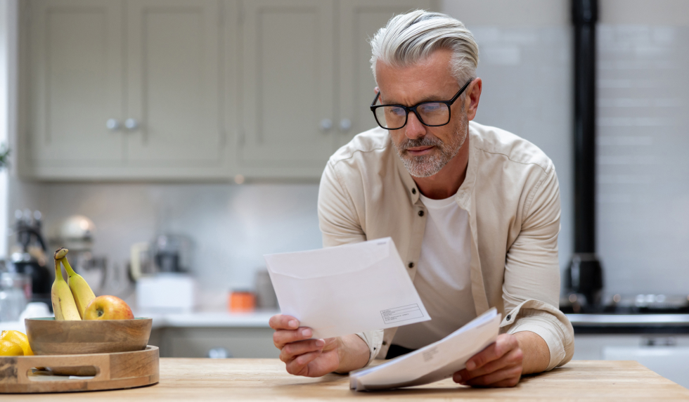 Man looking at his mail in the kitchen