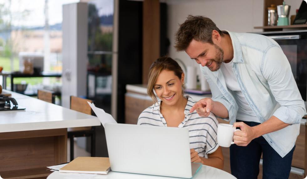 Couple in kitchen looking at accounts