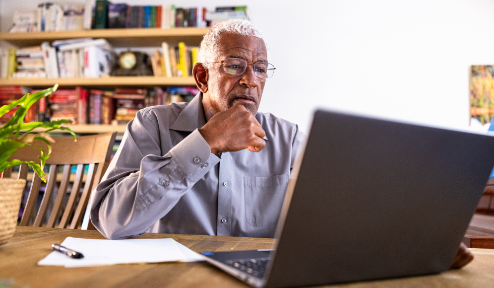 Man sitting at a table talking on his phone