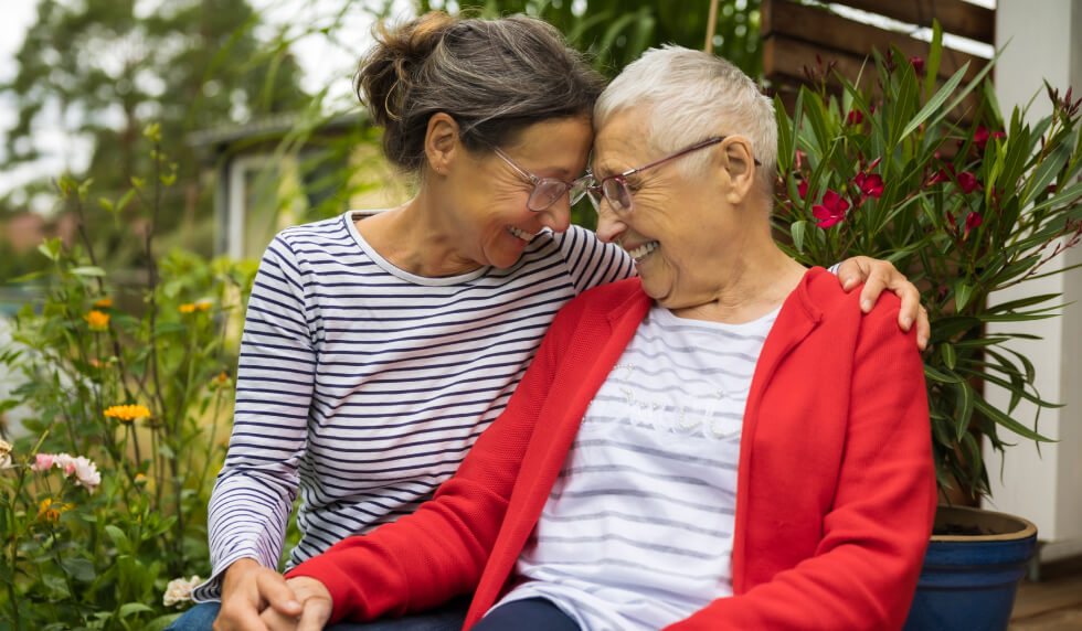 happy elderly women hugging