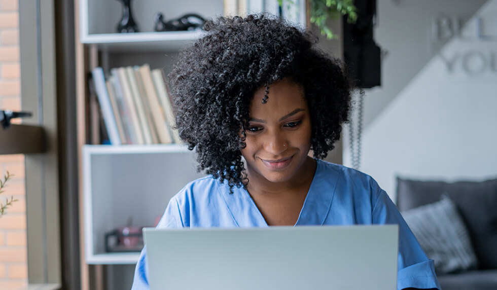 woman with curly hair using laptop