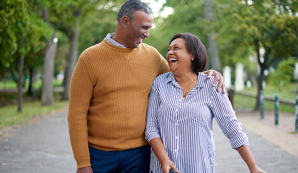 Elderly couple walking and laughing