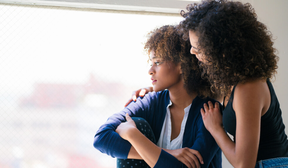 woman consoling another woman