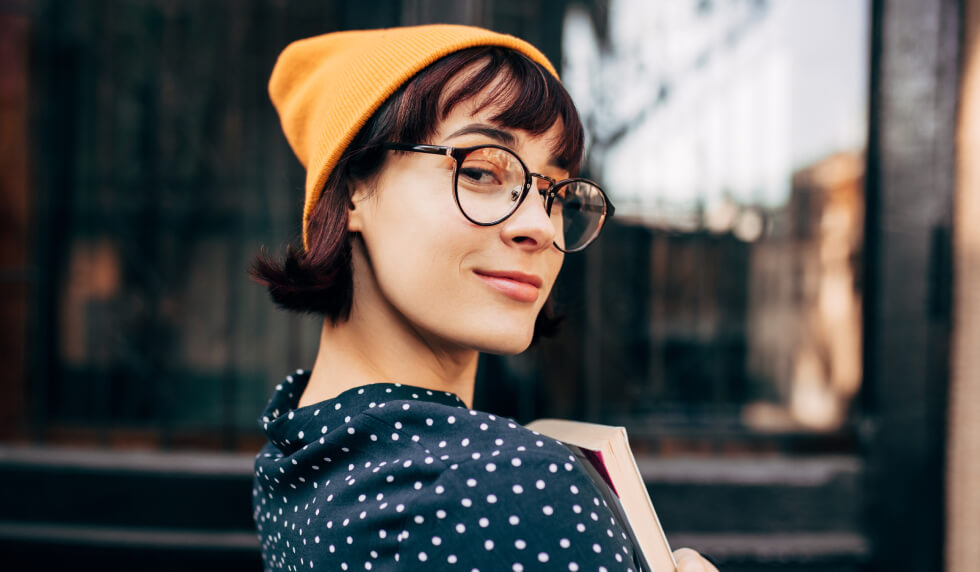 woman in yellow beanie and glasses