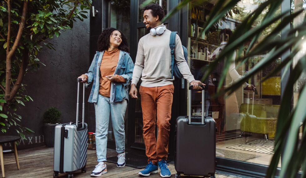 man and woman ready to travel with suitcases