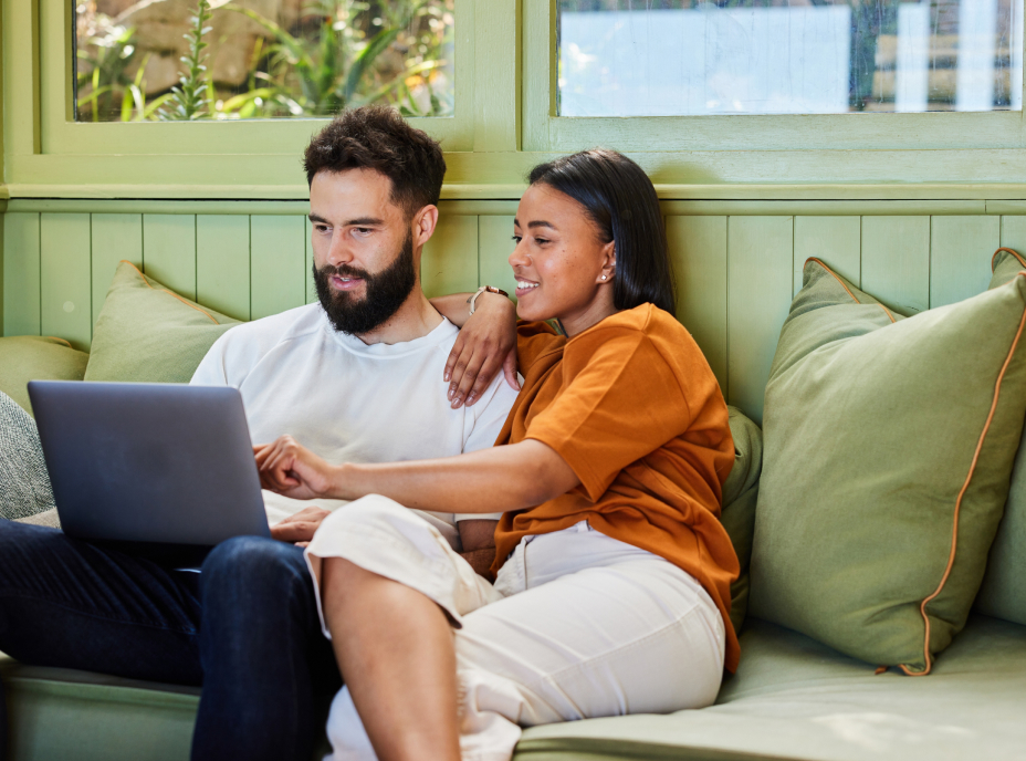 couple on couch looking at computer